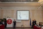 Na zdjęciu prelegent podczas prezentacji, na ścianie ekran z prezentacją