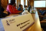 Informacja na stole o treści BCP management and Evaluation Team, widoczne logo CELBET i uczestnicy spotkania.