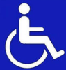 Symbol osoby niepełnosprawnej ruchowo - osoba niepełnosprawna na wózku inwalidzkim, na niebieskim tle
